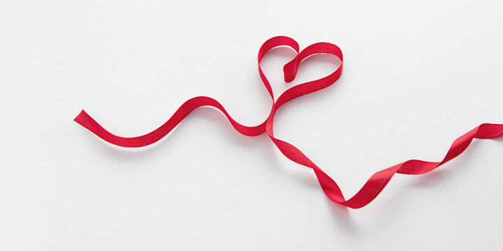 A red ribbon in heart shape