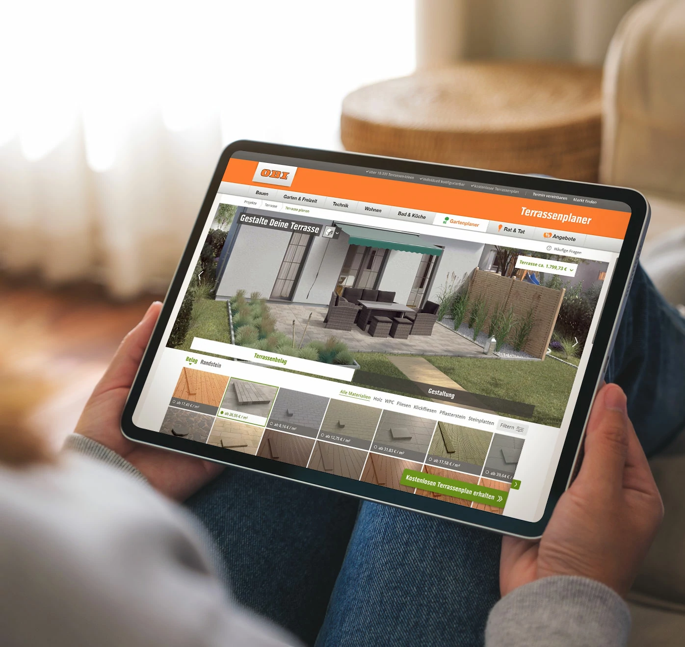 Tablet on a person's lap. There you can see an outdoor terrace and a configurator that is currently being used to select different floor coverings for the terrace.